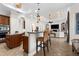 Kitchen island featuring custom cabinets, granite countertops, stainless steel appliances, and seating at 186 Portofino Dr, Nokomis, FL 34275