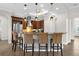 Kitchen island with custom cabinets, granite countertops, stainless steel appliances, and seating at 186 Portofino Dr, Nokomis, FL 34275