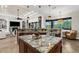 Kitchen featuring custom cabinets, granite countertops, stainless steel appliances, and island seating at 186 Portofino Dr, Nokomis, FL 34275