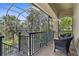 Screened lanai featuring wicker furniture and a view of the mature trees at 186 Portofino Dr, Nokomis, FL 34275