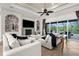 Comfortable living room showcasing a fireplace, large screen TV, and access to an outdoor pool area at 186 Portofino Dr, Nokomis, FL 34275