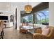 Sun-filled breakfast nook with wicker chairs and marble-topped table provides views of the screened in lanai and pool at 186 Portofino Dr, Nokomis, FL 34275