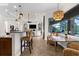 Bright living room boasts an open floor plan with a bar, tile floors, and views of the screened in lanai at 186 Portofino Dr, Nokomis, FL 34275