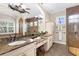 Elegant main bathroom features double sinks, marble countertops, and a walk-in shower at 186 Portofino Dr, Nokomis, FL 34275