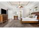 Spacious main bedroom features hardwood floors, a large bed, and access to the ensuite bathroom at 186 Portofino Dr, Nokomis, FL 34275