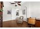 Home office features hardwood floors, an accent chair, ceiling fan and views into the foyer at 186 Portofino Dr, Nokomis, FL 34275