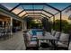 Spacious screened patio with dining area, bar, and pool view, ideal for outdoor dining and entertaining at 186 Portofino Dr, Nokomis, FL 34275