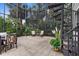 Covered patio featuring a spiral staircase, tropical plants, and a seating area, providing a relaxing outdoor space at 186 Portofino Dr, Nokomis, FL 34275