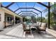 Covered patio with outdoor dining set, bar area, overlooking the pool and tropical landscaping at 186 Portofino Dr, Nokomis, FL 34275
