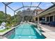 Stunning screened pool and spa with outdoor bar, creating a perfect setting for entertaining and enjoying the view at 186 Portofino Dr, Nokomis, FL 34275