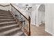 A carpeted staircase with wood and wrought iron banister leads to the upper level, enhancing the home's architectural detail at 186 Portofino Dr, Nokomis, FL 34275