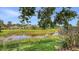 Backyard featuring a well-manicured lawn and waterfront view at 201 Vestavia Dr, Venice, FL 34292