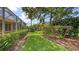 Lush backyard with a walking path and tropical landscaping at 201 Vestavia Dr, Venice, FL 34292