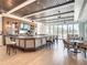 Elegant bar area with rich wood accents, modern seating, and views of the outdoors for a relaxing atmosphere at 201 Vestavia Dr, Venice, FL 34292