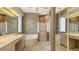 Bright bathroom featuring a dual vanity, soaking tub, and separate glass-enclosed shower at 201 Vestavia Dr, Venice, FL 34292