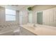 Well-lit bathroom with a single sink vanity, and shower over tub at 201 Vestavia Dr, Venice, FL 34292