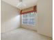 Cozy bedroom featuring a ceiling fan and large window with bright natural light at 201 Vestavia Dr, Venice, FL 34292