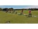 Spacious driving range with golfers practicing their swing in a scenic, open-air setting at 201 Vestavia Dr, Venice, FL 34292