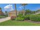 Inviting single-story home featuring a tile roof, lush landscaping, and a two-car garage at 201 Vestavia Dr, Venice, FL 34292