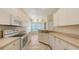 Well-lit kitchen features a full range of appliances and tile flooring at 201 Vestavia Dr, Venice, FL 34292