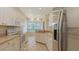 Modern kitchen featuring stainless steel appliances, tile flooring, and bright bay window at 201 Vestavia Dr, Venice, FL 34292