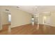 Open-plan living area featuring hardwood floors, ceiling fan, and access to other rooms at 201 Vestavia Dr, Venice, FL 34292