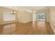 Sunlit living room boasts hardwood floors, a chandelier, and access to the screened lanai at 201 Vestavia Dr, Venice, FL 34292