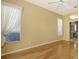 Inviting main bedroom with hardwood floors, fan, and plenty of natural light at 201 Vestavia Dr, Venice, FL 34292