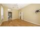Spacious main bedroom with wood floors, ceiling fan, access to the main bathroom at 201 Vestavia Dr, Venice, FL 34292