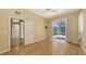 Bedroom boasts hardwood floors, ceiling fan, slider leading to the pool at 201 Vestavia Dr, Venice, FL 34292