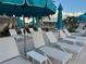 A relaxing outdoor pool with lounge chairs and umbrellas, perfect for enjoying the sun and shade at 201 Vestavia Dr, Venice, FL 34292