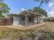 Screened patio and landscaped backyard with gravel accents at 2020 E Crest Dr, Englewood, FL 34223