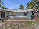 Exterior of the home with a patio, grill, and sunshade at 2020 E Crest Dr, Englewood, FL 34223