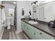 Bathroom with updated vanity, mirror, and modern vinyl flooring at 2020 E Crest Dr, Englewood, FL 34223