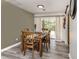 Dining area with wooden table set, sliding doors to patio, and open to kitchen at 2020 E Crest Dr, Englewood, FL 34223