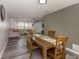 Open-concept dining room with hardwood table, hardwood chairs, and vinyl flooring at 2020 E Crest Dr, Englewood, FL 34223