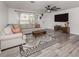 Comfortable living room featuring stylish rug, decor and light gray sectional sofa at 2020 E Crest Dr, Englewood, FL 34223
