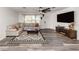 A well-lit living room with a large sectional sofa and entertainment center at 2020 E Crest Dr, Englewood, FL 34223