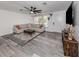 Living room featuring large sectional, gray flooring, and dark ceiling fan at 2020 E Crest Dr, Englewood, FL 34223