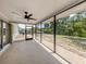 A screened-in patio with outdoor ceiling fan and backyard views at 2020 E Crest Dr, Englewood, FL 34223