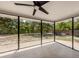 View of outdoor ceiling fan, screened-in patio, and spacious backyard at 2020 E Crest Dr, Englewood, FL 34223