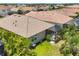 Aerial view of backyard showcasing the covered patio, lush green lawn, and meticulously kept roof at 2034 Mesic Hammock Way, Venice, FL 34292