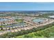 Sprawling aerial view of the community, featuring multiple homes, serene lakes, and lush greenery at 2034 Mesic Hammock Way, Venice, FL 34292