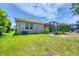 This backyard featuring a covered patio and lush green lawn, is the perfect outdoor oasis at 2034 Mesic Hammock Way, Venice, FL 34292