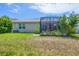 Enjoy this backyard featuring a covered patio and lush green lawn, creating a serene outdoor oasis at 2034 Mesic Hammock Way, Venice, FL 34292
