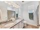 Bright bathroom features double vanity with granite countertop, tiled floors, and framed mirror at 2034 Mesic Hammock Way, Venice, FL 34292