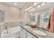 Well-lit bathroom featuring a double vanity, a bathtub, granite countertops, and a shower at 2034 Mesic Hammock Way, Venice, FL 34292