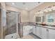 Well-lit bathroom featuring a shower, a bathtub, granite countertops, and a double vanity at 2034 Mesic Hammock Way, Venice, FL 34292