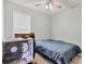 This simple bedroom features a cozy bed, modern computer setup and neutral wall color at 2034 Mesic Hammock Way, Venice, FL 34292