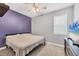This cozy bedroom features neutral walls, a ceiling fan, and a comfortable bed at 2034 Mesic Hammock Way, Venice, FL 34292